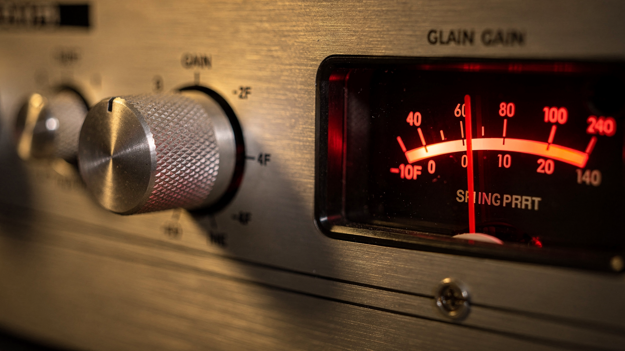 A preamp gain knob and VU meter pushed into the red zone